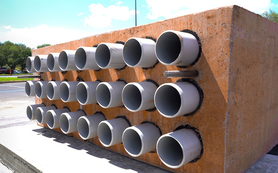 Precast duct bank concrete section with multiple conduit openings